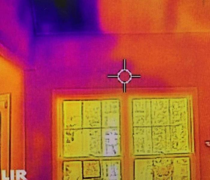 A ceiling with red and orange dry areas and dark purple colors show possible water intrusion areas 